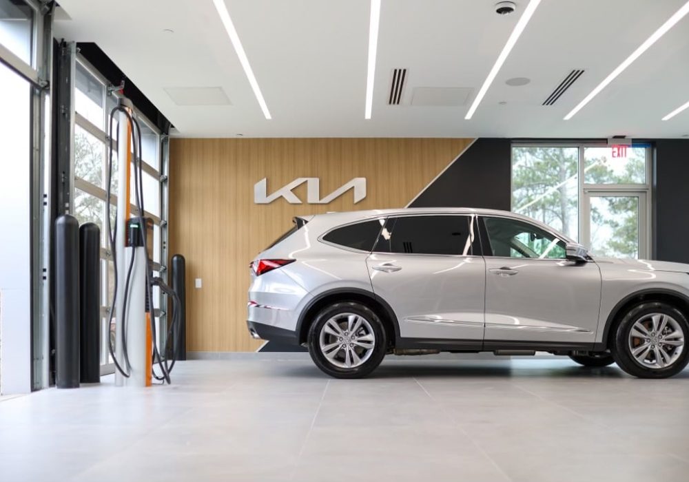 An electric vehicle charging station inside the showroom, emphasizing Kia's commitment to sustainability and innovation.