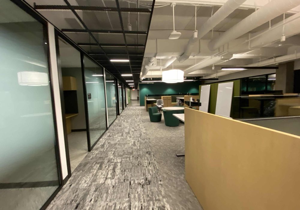 Office corridor with glass-walled meeting rooms and open workspaces at Graphic Packaging International.