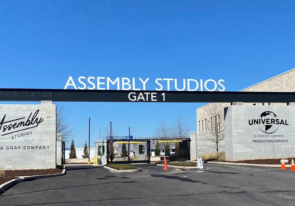 Gate 1 entrance to Assembly Studios featuring Universal Production Services signage and modern security structures.